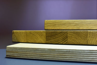 Close-up of books on table against wall