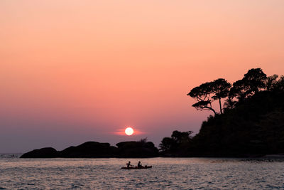 Scenic view of sea against orange sky