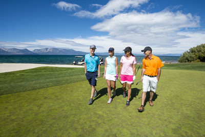 Four people playing golf at edgewood tahoe in stateline, nevada.