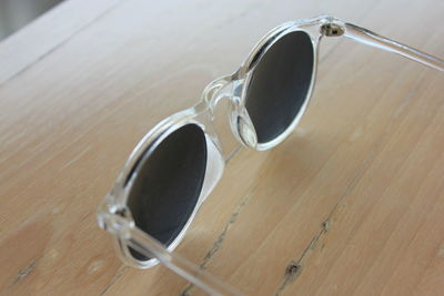 Close-up of sunglasses on wooden table