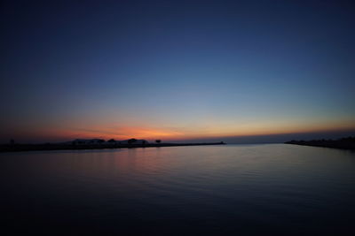 Scenic view of sea against clear sky at sunset