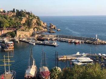 High angle view of townscape by sea against sky