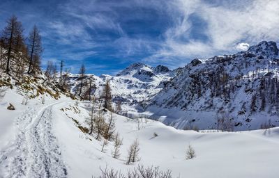 Scenic view of snow covered mountains against sky