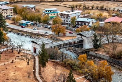 High angle view of buildings and trees in city