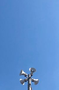 Low angle view of street light against clear blue sky