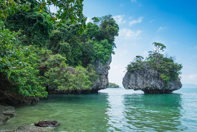 Scenic view of rocks in sea against sky