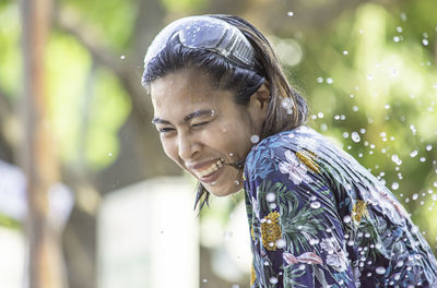 Side view of smiling young woman