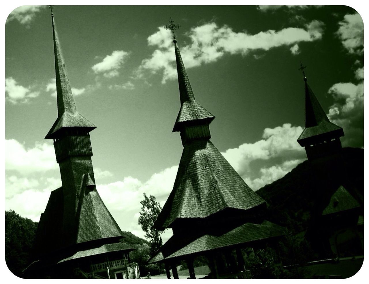 low angle view, transfer print, building exterior, architecture, built structure, sky, auto post production filter, cloud - sky, religion, tower, cloud, cloudy, church, tall - high, spirituality, place of worship, cross, day, outdoors