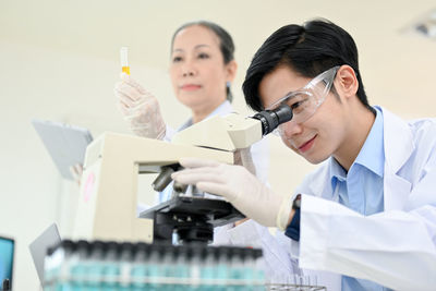 Female doctor with syringe and patient in laboratory