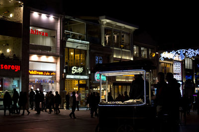 People at illuminated city at night