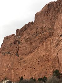 Low angle view of rocky mountain against sky