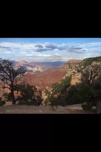 Scenic view of landscape against cloudy sky