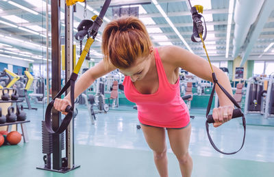 Woman exercising with resistance band at gym