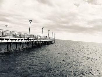 Pier over sea against sky