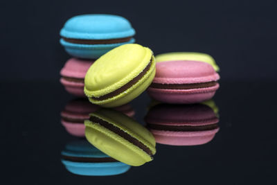 Close-up of multi colored macaroons over black background