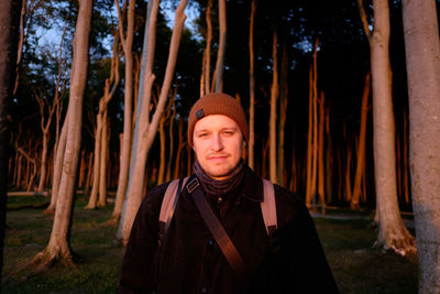 Portrait of young man standing in forest