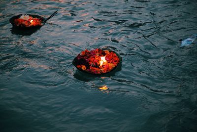 High angle view of religious offerings floating on water in ganges river