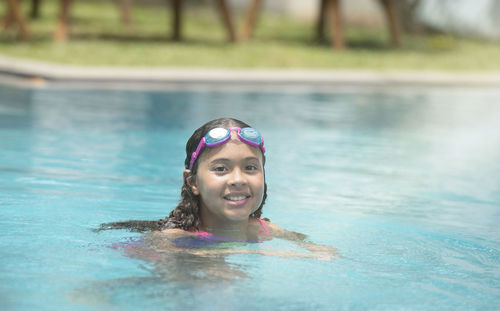 Portrait of smiling boy swimming in pool