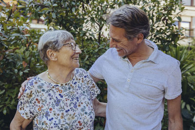 Happy mother and adult son in he garden