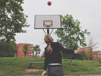 Rear view of girl playing with ball