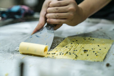 Close-up of person preparing icecream on table