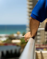 Midsection of man against sea against sky