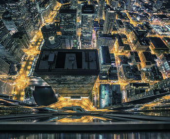 High angle view of illuminated buildings in city at night