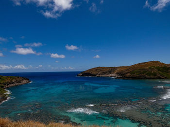 Scenic view of sea against blue sky