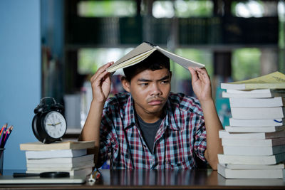 Portrait of young man sitting on table