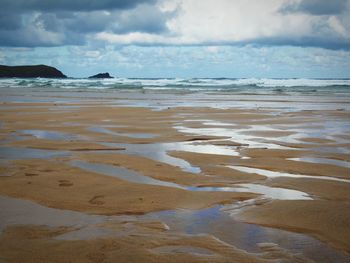 Scenic view of sea against cloudy sky