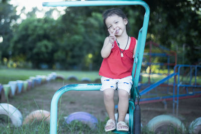 Portrait of young woman exercising in park