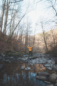 Rear view of woman standing in water