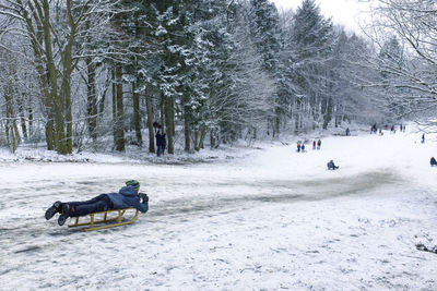 High angle view of man riding on sled during winter 