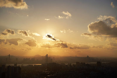 View of buildings in city during sunset