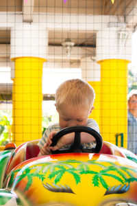 Smiling boys in amusement park ride