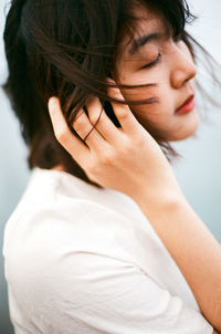 Close-up of young woman with eyes closed