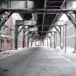 Empty road leading towards building