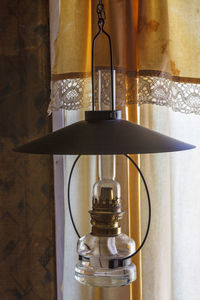 Close-up of illuminated lamp on table at home