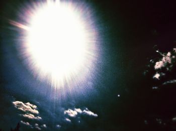 Low angle view of sun shining through trees