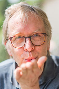 Close-up portrait of man wearing eyeglasses