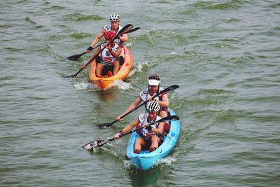 High angle view of athletes kayaking on river