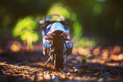 Close-up of toy motorcycle on field