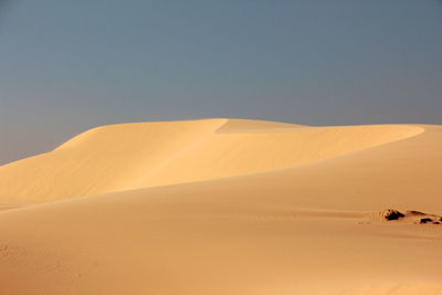 Scenic view of desert against clear sky