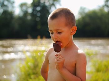 Close-up of boy eating in water