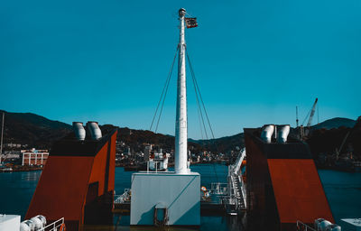 View of harbor against clear blue sky
