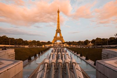 Tower of building against cloudy sky