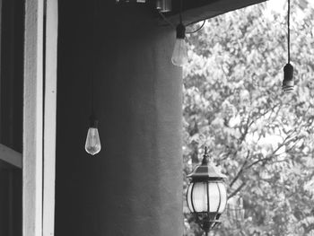 Low angle view of light bulb hanging on wall