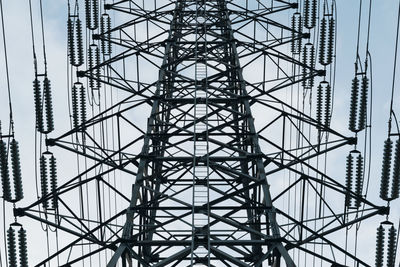 Low angle view of electricity pylon against sky