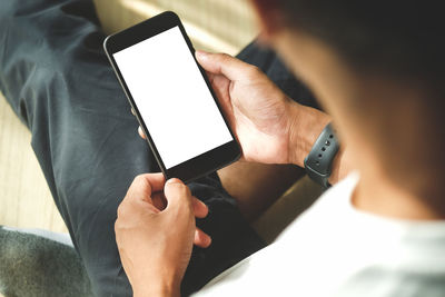 Midsection of man using mobile phone