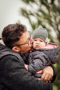 Father and son with baby